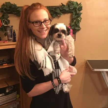 Andrea holding small black and white dog